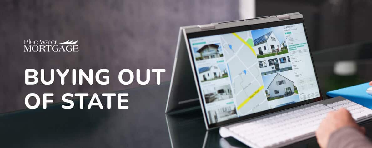 Laptop on a desk looking at homes. Persons hands near keyboard. Text reads Blue Water Mortgage Buying Out Of State
